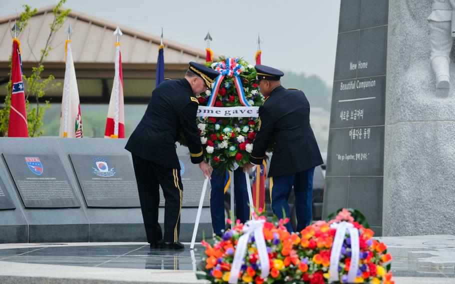 U.S. Forces Korea commander Gen. Robert Abrams and Command Sgt. Maj. Walter Tagalicud place a wreath at the United Nations Command Memorial during a Memorial Day ceremony at Camp Humphreys, South Korea, Monday, May 25, 2020.