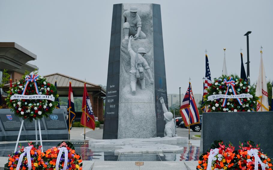 Wreaths and flags surround the United Nations Command Memorial during a Memorial Day service at Camp Humphreys, South Korea, Monday, May 25, 2020.