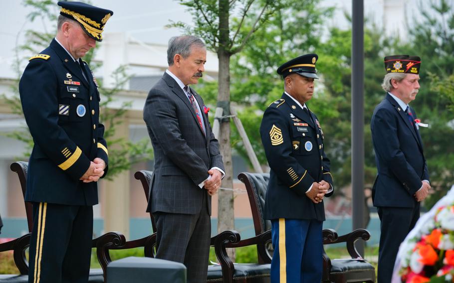 From left to right, U.S. Forces Korea commander Gen. Robert Abrams, U.S. Ambassador to South Korea Harry Harris, USFK Command Sgt. Maj. Walter Tagalicud and Veteran of Foreign Wars District 3 commander Donald Kelley observe a moment of silence during a Memorial Day ceremony at Camp Humphreys, South Korea, Monday, May 25, 2020.