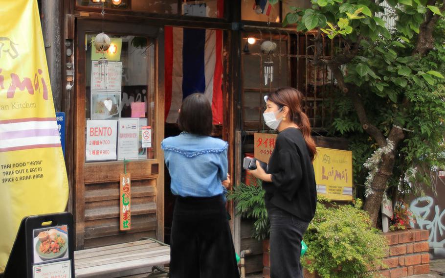 People check out lunchtime takeout options in Omotesando, Tokyo, Friday, May 22, 2020.