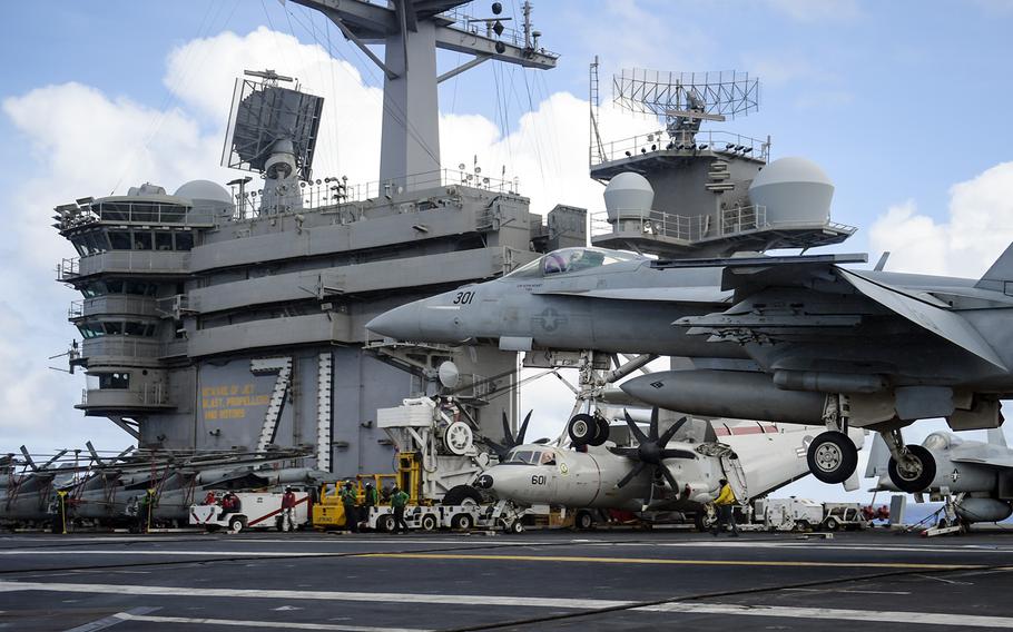 An F/A-18E Super Hornet lands aboard the aircraft carrier USS Theodore Roosevelt in the Philippine Sea, May 25, 2020.