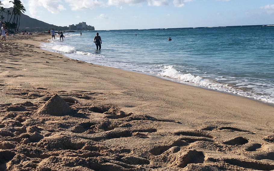 People spend time at Duke Kahanamoku Beach in Oahu, Hawaii, Sept. 18, 2019.