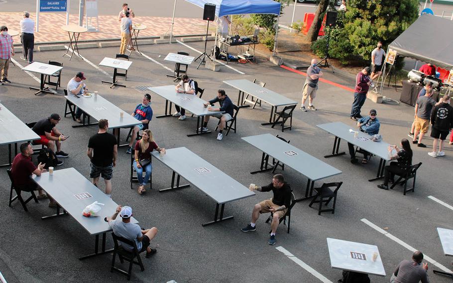 Sailors at Sasebo Naval Base, Japan, quench their thirst at a beer garden outside the enlisted club that opened Friday, May 29, 2020.