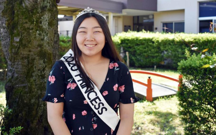 Aika Davis, a junior at Zama Middle High School and this year's prom princess, poses during a small ceremony for the prom court outside the school at Camp Zama, Japan, May 29, 2020.