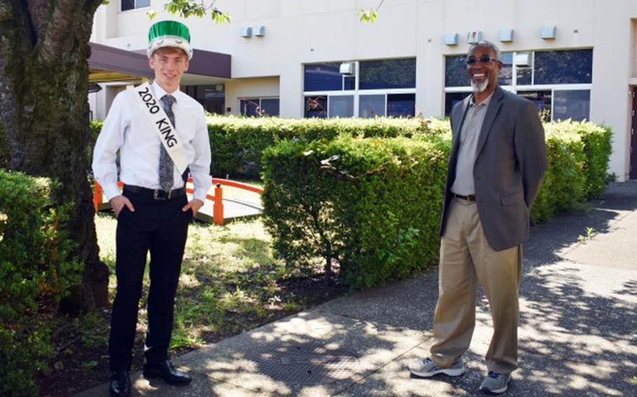 Jason Giles, a senior at Zama Middle High School and this year's prom king, poses for a socially distanced photo with Principal Wayne Carter, during a small ceremony for the prom court at Camp Zama, Japan, May 29, 2020.