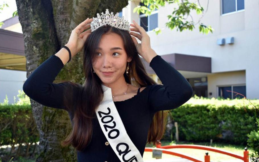 Leah Sakamoto-Flack, a senior at Zama Middle High School and this year's prom queen, puts on her tiara during a small ceremony for the prom court outside the school at Camp Zama, Japan, May 29, 2020.