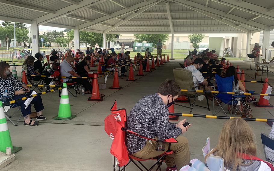 People and families practice social distancing during an outdoor church service at Yokosuka Naval Base, Japan, Sunday, May 31, 2020.