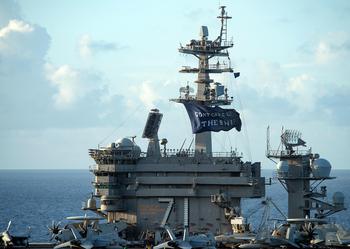 The aircraft carrier USS Theodore Roosevelt flies a replica of Capt. Oliver Hazard Perry's Don't Give Up the Ship flag in the Philippine Sea, June 3, 2020.