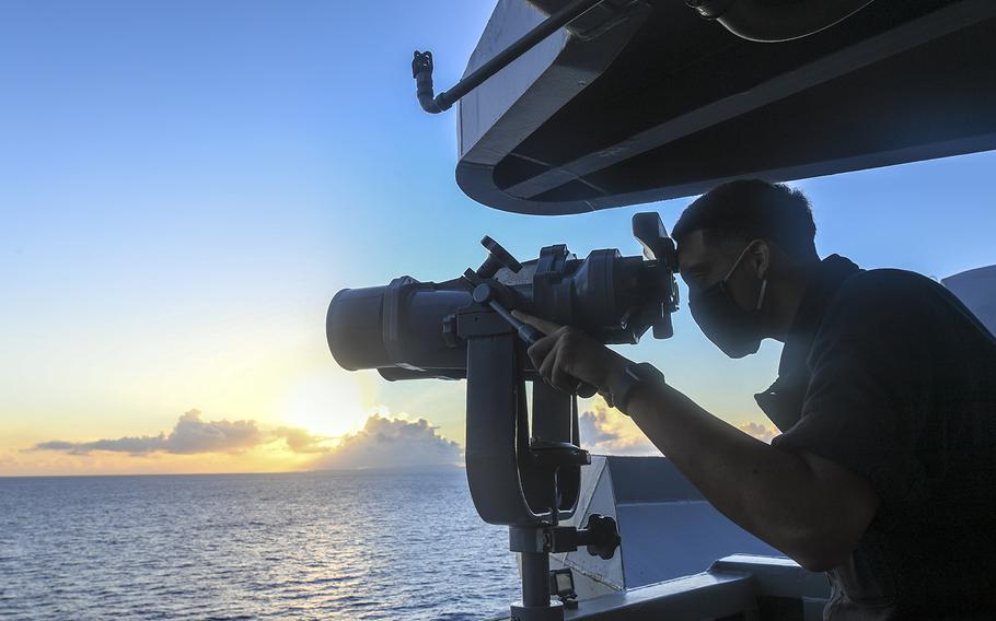 A sailor aboard the aircraft carrier USS Theodore Roosevelt searches for surface contacts in the Philippine Sea, June 3, 2020.