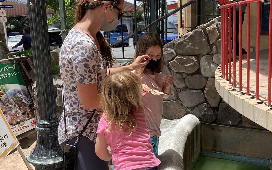 Marine Corps spouse Kristin Edick and her daughters Ellisyn and Logan shop at American Village in Chatan, Okinawa, Thursday, June 4, 2020.