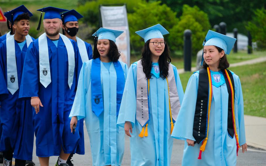 Valedictorian Kelly Kenyon leads graduating seniors from Osan Middle High School during a parade at Osan Air Base, South Korea, Wednesday, June 3, 2020.