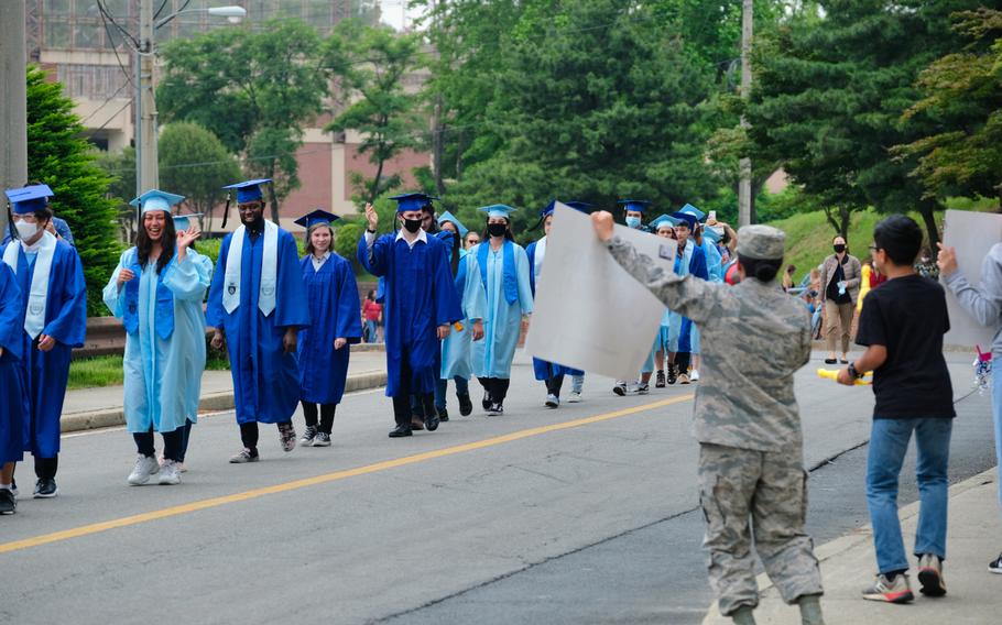Graduating seniors from Osan Middle High School are showered with adulation during a parade at Osan Air Base, South Korea, Wednesday, June 3, 2020.