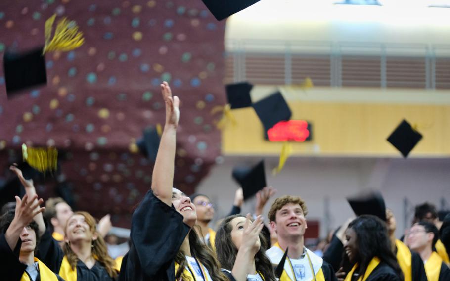 Humphreys High School seniors toss their caps into the air during their graduation ceremony inside Collier Community Fitness Center at Camp Humphreys, South Korea, Thursday, June 4, 2020.