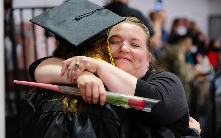 A Humphreys High School graduate gives her mother a rose during a ceremony inside Collier Community Fitness Center at Camp Humphreys, South Korea, Thursday, June 4, 2020.