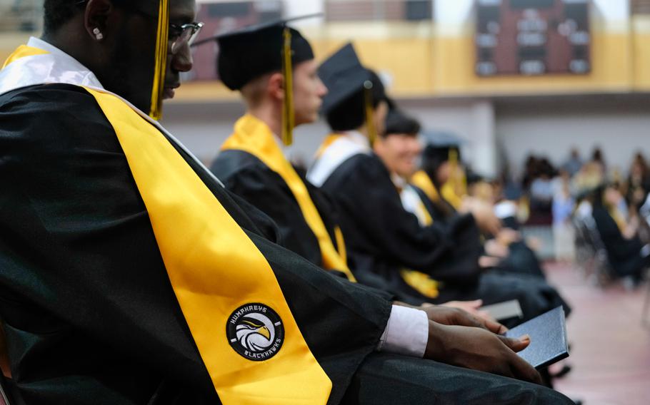 A Humphreys High School graduate looks at his diploma during his graduation ceremony inside Collier Community Fitness Center at Camp Humphreys, South Korea, Thursday, June 4, 2020.