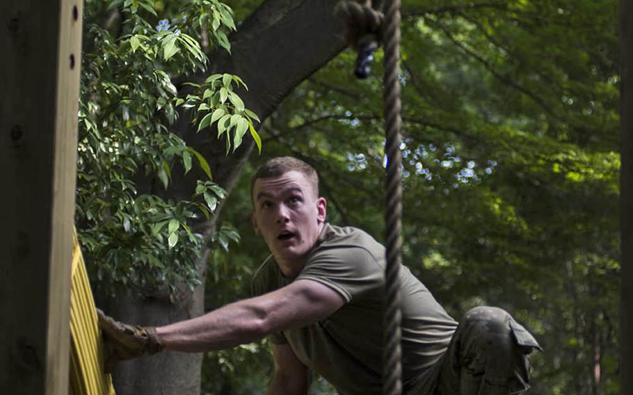 A soldier works through an obstacle course during a functional fitness test competition at Camp Zama, Japan, Tuesday, June 9, 2020.