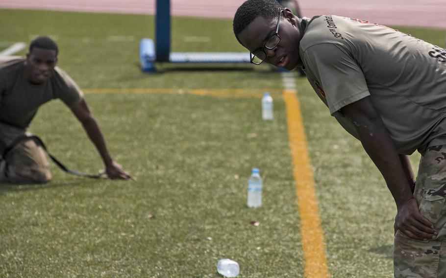 Soldiers catch their breath after completing a five-mile run with eight obstacle stations during an Army Week competition at Camp Zama, Japan, Tuesday, June 9, 2020. 