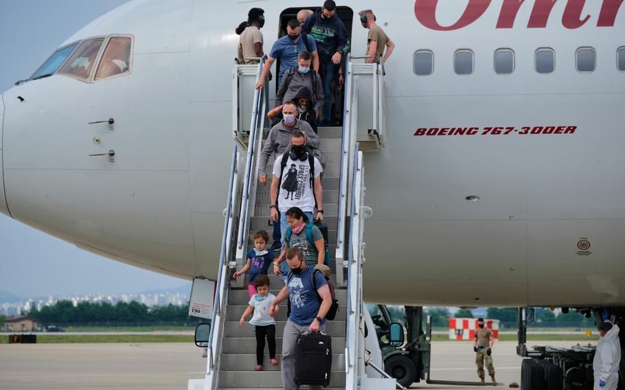 Passengers exit a Patriot Express flight at Osan Air Base, South Korea, Wednesday, June 10, 2020.