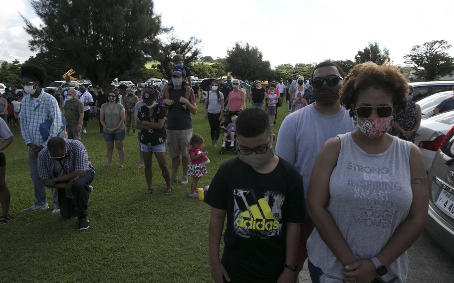 People attend a vigil for George Floyd, an African American killed by a white police officer last month in Minneapolis, at Kadena Air Base, Okinawa, Saturday, June 13, 2020.