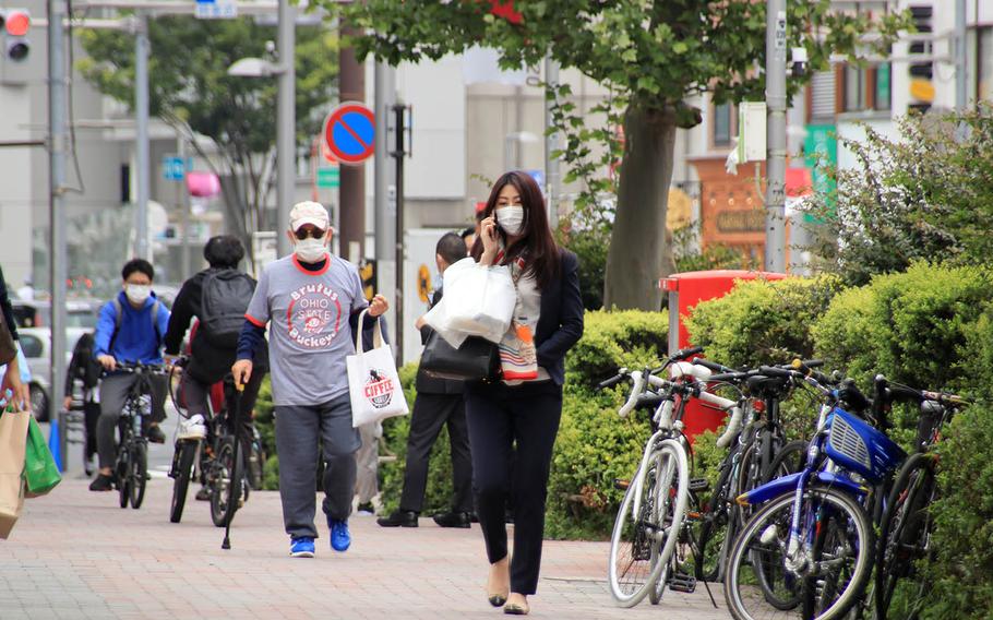 People stroll and shop in Tokyo's Omotesando district during lunch time. 