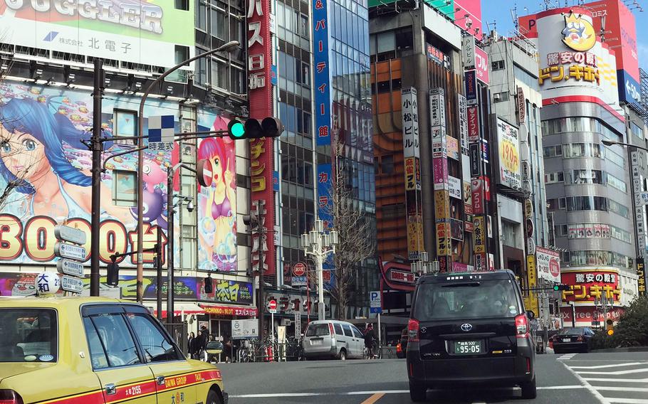 Vehicles travel past the Kabukicho entertainment district in Shinjuku, Tokyo, Jan. 26, 2019.