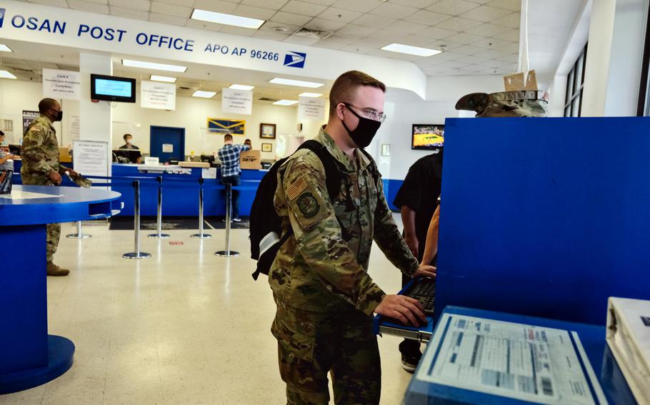 Staff Sgt. Dustin Traylor of the 51st Fighter Wing uses a computer to fill out a customs form inside the post office at Osan Air Base, South Korea, Tuesday, June 16, 2020.