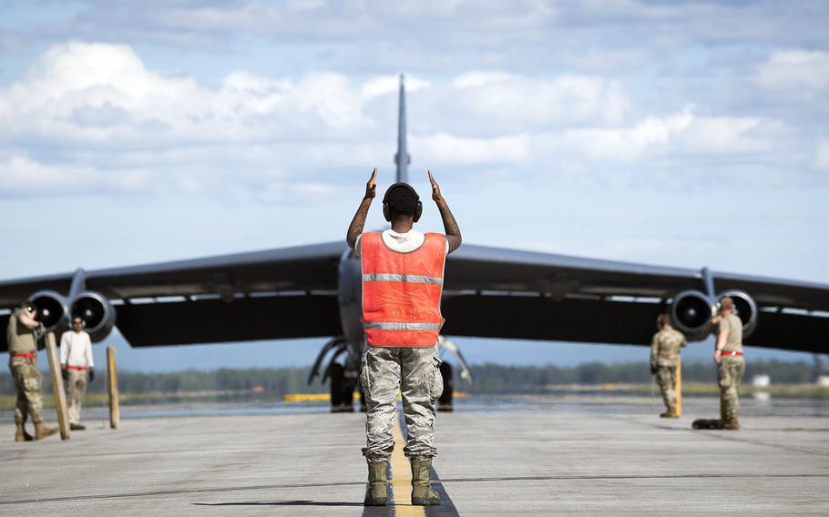 Senior Airman Jar'quayla Doss of the 96th Aircraft Maintenance Unit marshalls a B-52H Stratofortress at Eielson Air Force Base, Alaska, Wednesday, June 17, 2020.