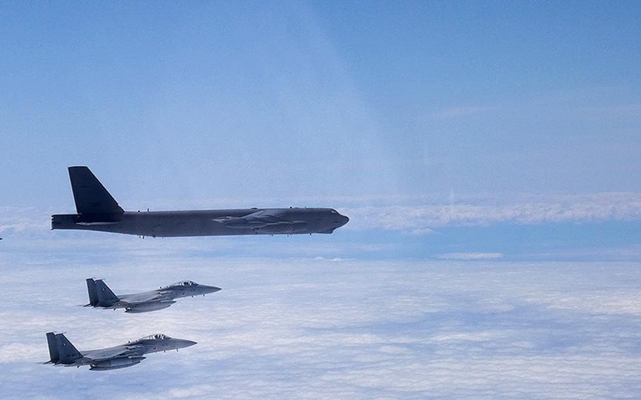 A B-52H Stratofortress deployed from Barksdale Air Force Base, La., flies between Japan and Korea alongside two Japan Air Self-Defense Force F-15s, Tuesday, June 16, 2020.