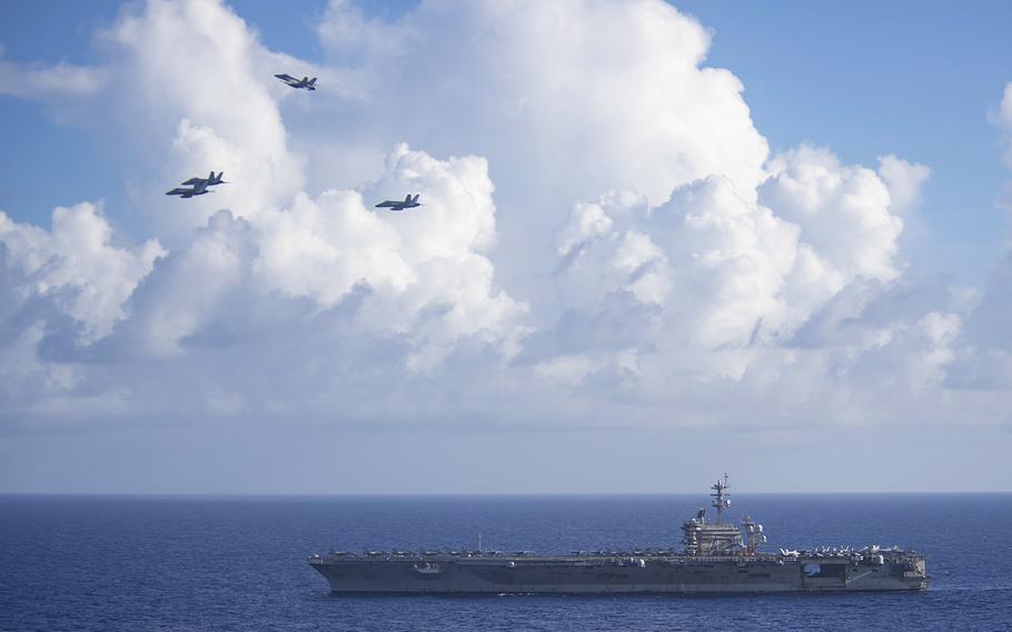 F/A-18 Super Hornets assigned to Carrier Air Wing 11 fly in the missing man formation over the aircraft carrier USS Theodore Roosevelt in the Philippine Sea, June 18, 2020. The formation honored Capt. Rinehart Wilke IV, a former commanding officer for Strike Fighter Squadron 154, who died of cancer in May.