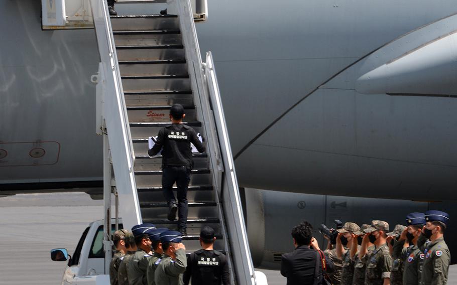 The last of 147 boxes holding the remains of South Korean service members killed during the Korean War is carried aboard a jet during a repatriation ceremony at Joint Base Pearl Harbor-Hickam, Hawaii, Tuesday, June 23, 2020.