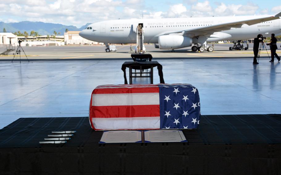 A box holding the remains of a South Korean service member rests in a hangar before being loaded onto a jet during a repatriation ceremony at Joint Base Pearl Harbor-Hickam, Hawaii, Tuesday, June 23, 2020.