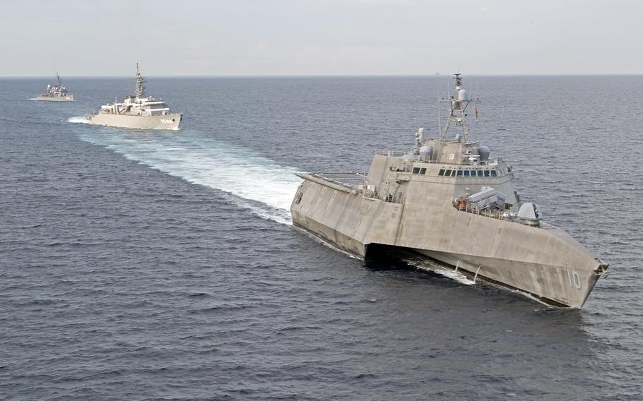 The littoral combat ship USS Gabrielle Giffords, right, trains with the Japan Maritime Self-Defense Force ships JS Kashima and JS Shimayuki in the South China Sea, Tuesday, June 23, 2020.