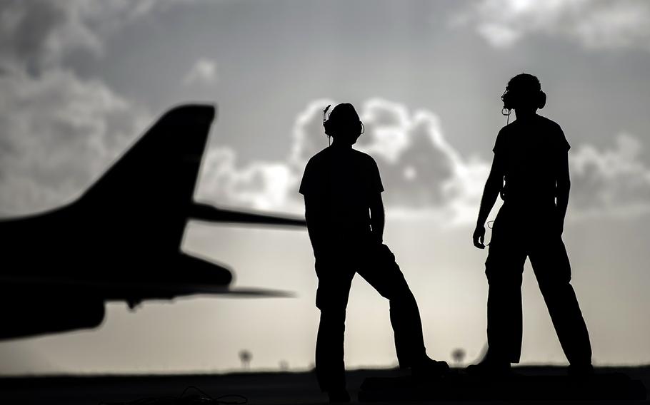 Airmen stand on the flight line at Andersen Air Force Base, Guam, May 26, 2020.