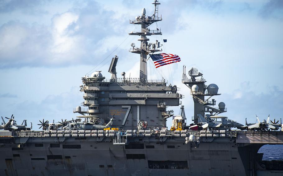 The aircraft carrier USS Theodore Roosevelt is seen from the USS Nimitz during dual-carrier training in the Philippine Sea, June 23, 2020.