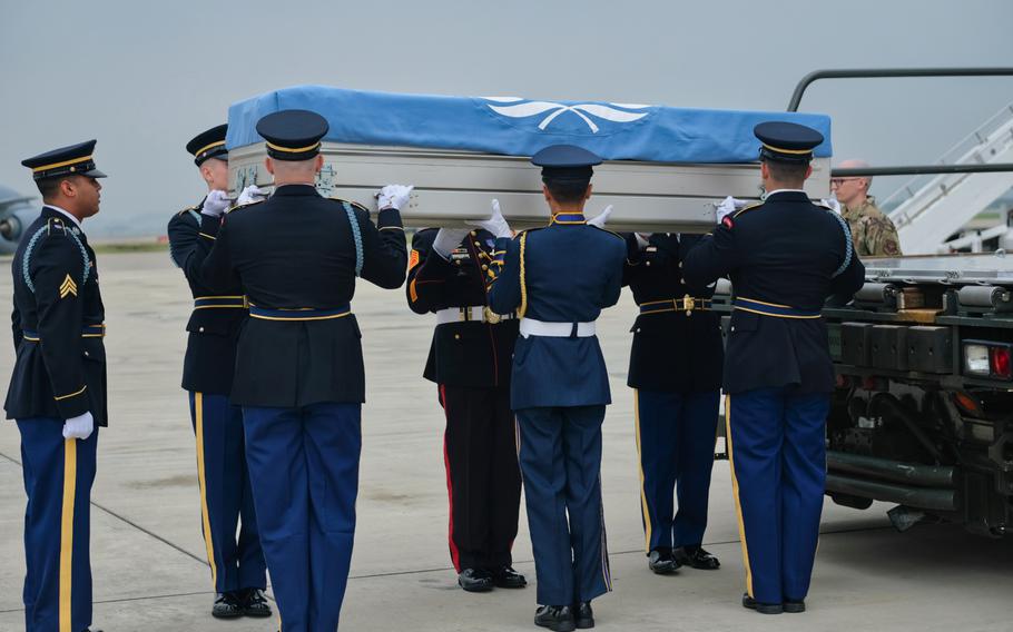 A United Nations Command honor guard carries the remains of six service members killed in the Korean War during a repatriation ceremony at Osan Air Base, South Korea, Friday, June 26, 2020.