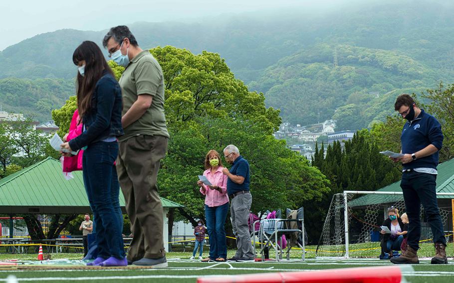 People attend an outdoor church service at Sasebo Naval Base, Japan, May 11, 2020.