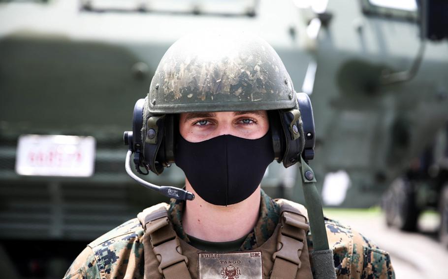 Marine Cpl. Tyler Wyatt wears a mask to protect against the coronavirus during exercise Caged Hydra at Camp Hansen, Okinawa, May 20, 2020.