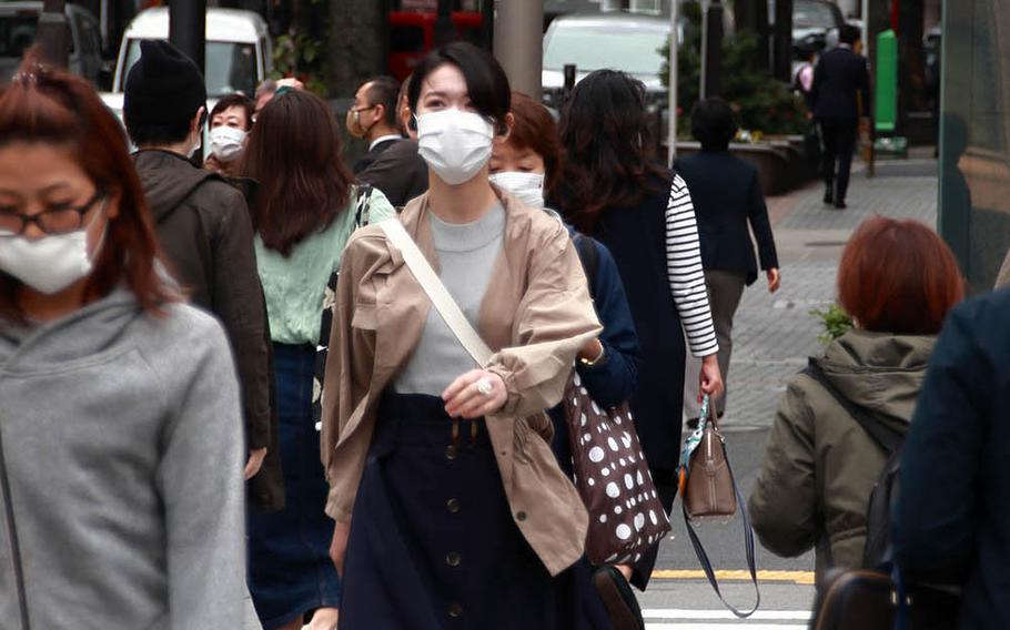 Pedestrians stroll through the Ometesando area of central Tokyo, May 22, 2020.