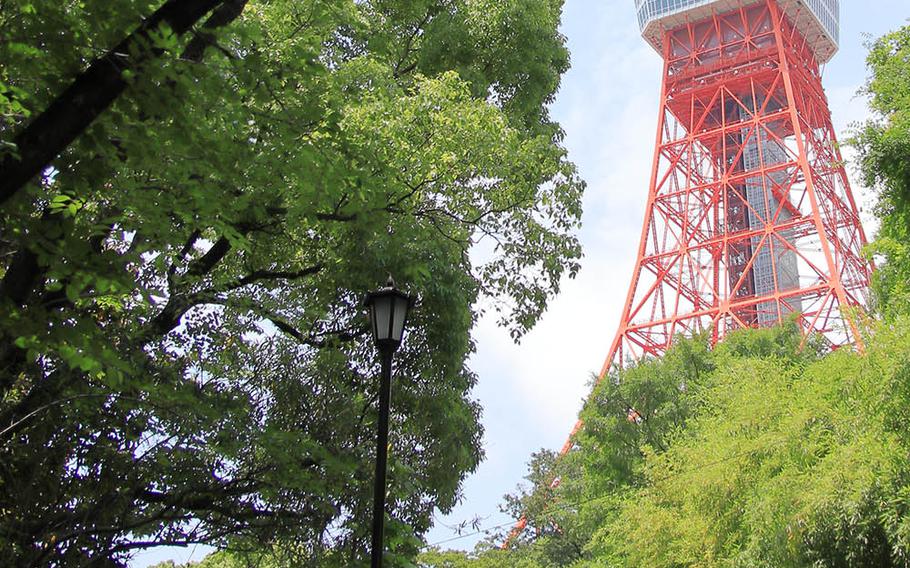 People wear masks as they walk near Tokyo Tower in central Tokyo, May 28, 2020.