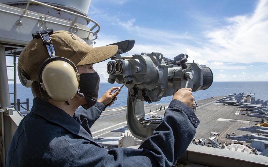 Seaman Alexander Chitty stands forward lookout watch on the signal bridge of the aircraft carrier USS Ronald Reagan in the South China Sea, July 16, 2020.