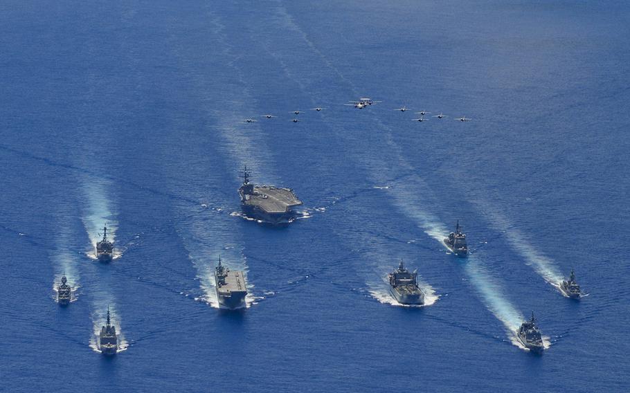 The Ronald Reagan Carrier Strike Group trains with Japan Maritime Self-Defense Force and Australian Defense Force vessels in the Philippine Sea, Tuesday, July 21, 2020.