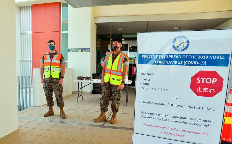 Marines wait to screen U.S. Naval Hospital Okinawa patients for the coronavirus in this photo posted to the hospital's Facebook page on July 15, 2020.