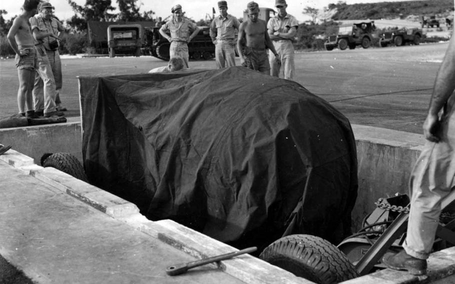 U.S. soldiers on Tinian prepare to load the Fat Man bomb for the atomic bombing mission to Nagasaki, Japan, on Aug. 9, 1945.