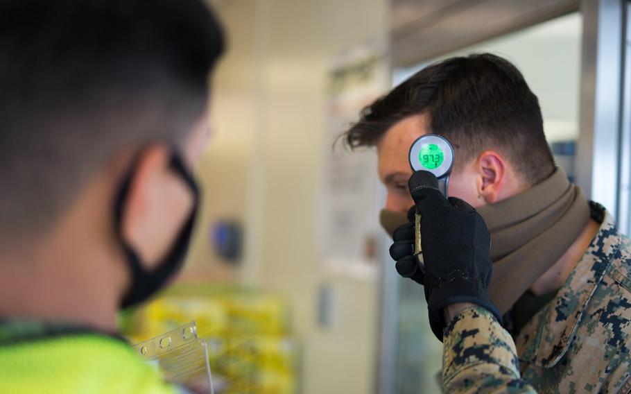 A Marine goes through a coronavirus screening at Camp Courtney, Okinawa, July 13, 2020.