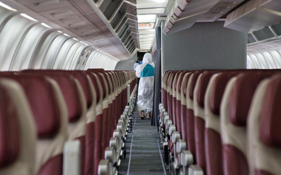 A sanitation crew works to disinfect the Patriot Express at Osan Air Base, South Korea, July 14, 2020.