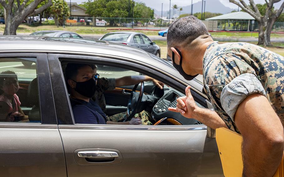 Col. Speros Koumparakis, commander of Marine Corps Base Hawaii, greets a family outside Mokapu Elementary School on base, July 28, 2020.