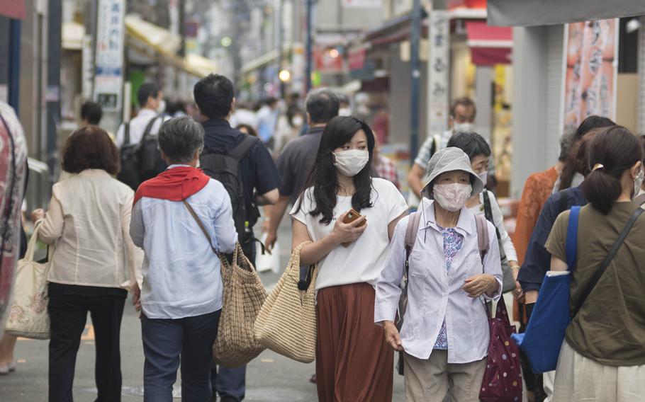 People wear masks while walking near Ofuna Station in Yokohama, Japan, July 29, 2020.