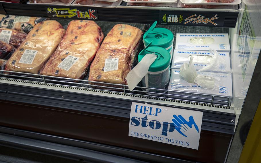 Sanitary wipes and disposable gloves are offered to commissary shoppers at Marine Corps Air Station Iwakuni, Japan, April 7, 2020.