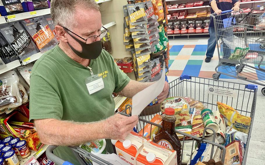 Samaritan Shopper Program volunteer Kim McCann checks a grocery list provided by a family in quarantine at Yokosuka Naval Base, Japan, Aug. 4, 2020. 