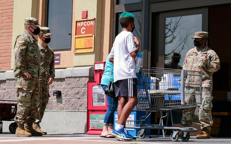 Soldiers and family members wait to enter the commissary at Camp Humphreys, South Korea, on Monday, Aug. 18, 2020.